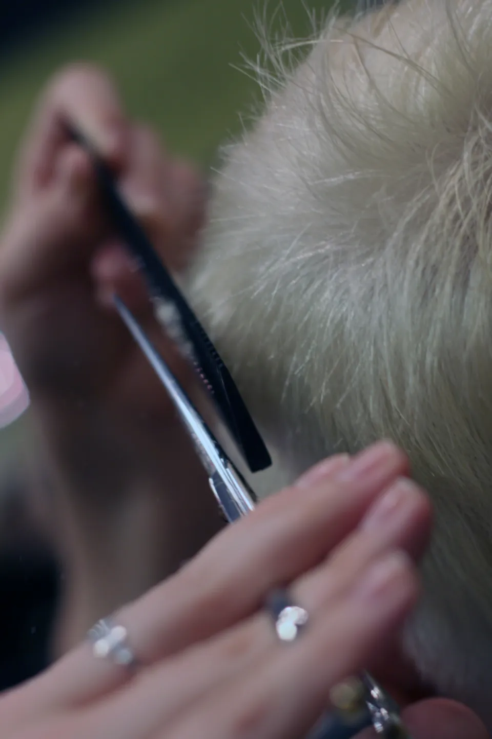 A stylist trimming hair