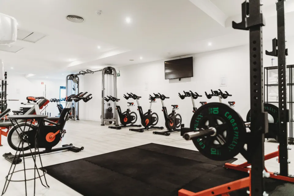 A bright gym floor with machines